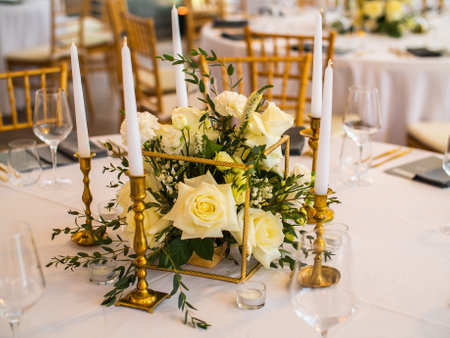 Wedding banquet concept. Chairs and round table for guests, served with cutler and, flowers and...