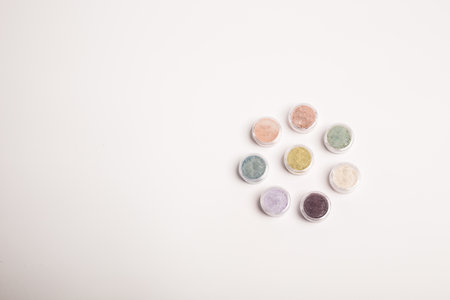 Many colorful natural mineral eyeshadows isolated on white background with copy space and empty space for textの写真素材