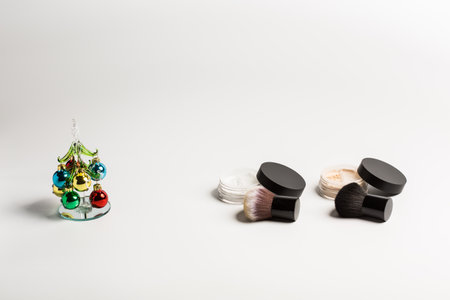 Mineral makeup powder twist seal sifter isolated on white background with brush copy space. Many beige foundation powder. Skin tone face cosmetic product sampleの写真素材