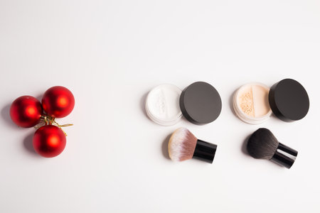 Mineral makeup powder twist seal sifter isolated on white background with brush copy space. Many beige foundation powder. Skin tone face cosmetic product sampleの写真素材