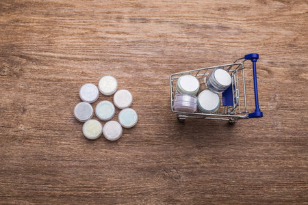 Many colorful natural mineral eyeshadows on wooden background with copy space and empty space for textの写真素材