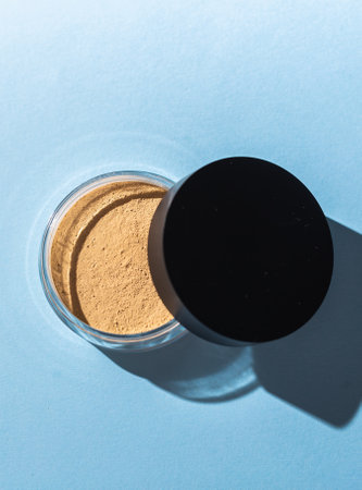 Mineral powder foundation isolated on blue background. Eco-friendly and organic beauty productsの写真素材