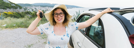 Banner car driver woman smiling showing new car keys and car. Female driving rented cabrio on summer...