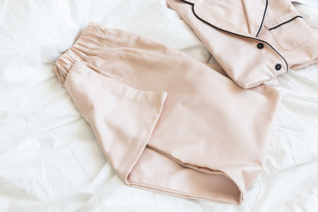 Ladies pajamas on bed. Pajama in shop top view. Advertise, sale, fashion and shopping concept.