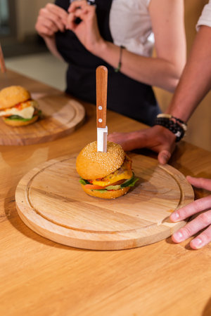 Beef burgers on wooden desk. Fat unhealthy food close-upの写真素材