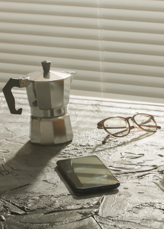 Breakfast with coffee moka pot and smartphone and eyeglasses. Morning meal and breakfast concept.の写真素材