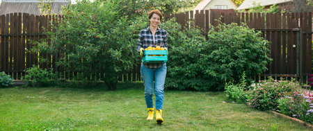 Banner Farmer woman holding wooden box full of fresh raw vegetables copy space and empty place for...