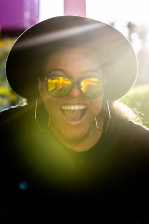 African american woman in an urban city area. Smiling generation z or millennial hipster girl posing...