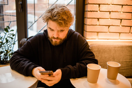 Social media and digital online concept - Happy young portrait man using smart phone with Social...