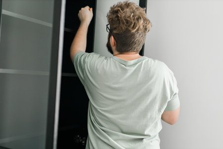 Portrait of man assembling furniture. Do it yourself furniture assembly at homeの写真素材