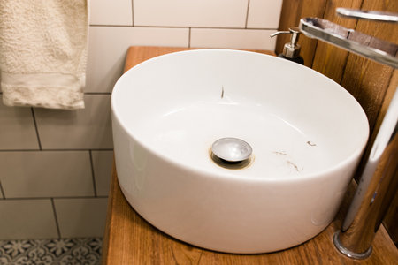 Water tap with dirty sink close up. chrome faucet wash basin. Hygiene and Cleaning hands and messy home concept.の写真素材