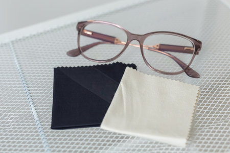 Glasses and rag for lens wipes on shelf - accessories for eyeglasses