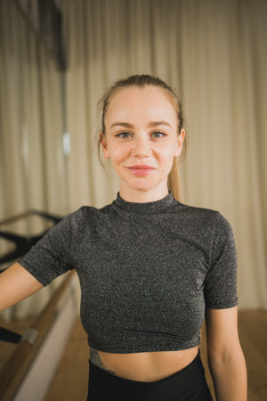 Active young woman portrait female ballet or contemporary dance teacher class in studio