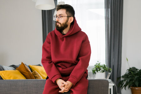 Sad man pondering about his life after a relationship breakup or bipolar disorder - depression asthenia , mental problem and anxiety disorder conceptの写真素材