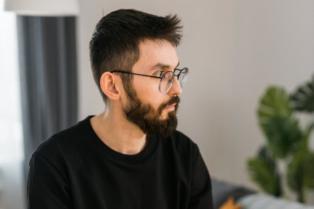 Sad man pondering about his life after a relationship breakup or bipolar disorder copy space - depression asthenia , mental problem and anxiety disorder conceptの写真素材