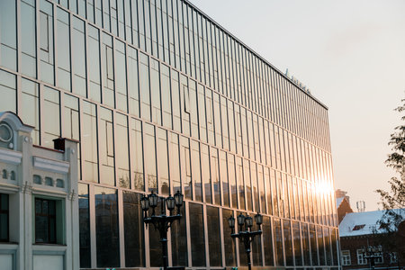 Street light in city winter season on background a glass facade building. Copy space and empty place...