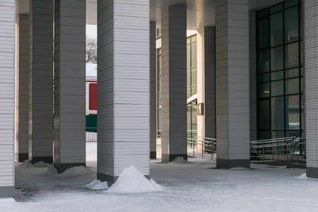 Street with building cold weather. Snow day in winter. Building in city center covered with snow.の写真素材