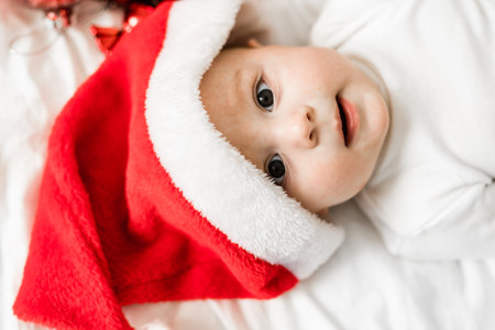 Beautiful little baby portrait celebrates Christmas. New Years holidays. Baby in a Christmas costume with giftの写真素材