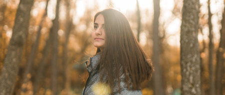 Banner beautiful indian woman generation z relaxing and feeling nature at autumn park in fall season copy space. Diversity and gen z youthの写真素材