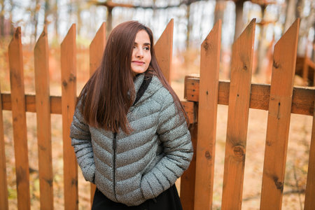 Close up portrait of pretty indian young woman enjoying warm autumn sunny day vacation outdoor copy space mockup. Generation z and gen z concept. Fall Seasonの写真素材
