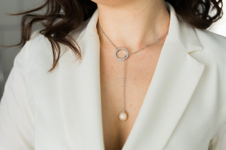 Womans decollete with a luxury jewelry. Unusual and elegant pendant. Close up shot of beautiful pendant with crystals. Women Accessories.の写真素材