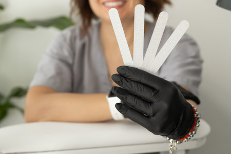 Female hands holds nails files for manicure and pedicure. Concept of polishing nails. Spa treatment beauty.の写真素材