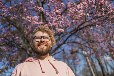 Man allergic enjoying after treatment from seasonal allergy at spring. Portrait of happy bearded man...