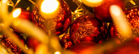 Banner close up of red Christmas balls baubles. Bokeh garlands. Xmas and holidays concept. Copy space and empty place for text, mock up greeting cardの写真素材