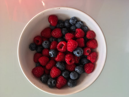 Close-up tasty ripe fresh summer berries - raspberry and blueberry
