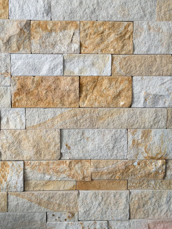 Close-up of a stone wall showcasing various earthy tones and textures. Background for text or copy...