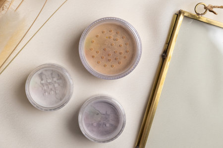Top view eye shadow and facial powder on natural background with dried flowers. Aesthetics of makeup...