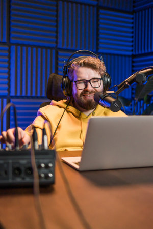 Live streaming with smiling millennial man as radio presenter with microphone, talk show or...