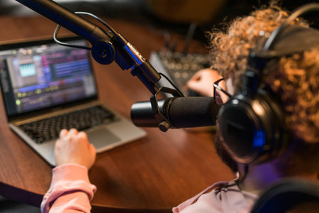 Handsome man radio DJ hosting a radio show, entertainment and communication conceptの写真素材