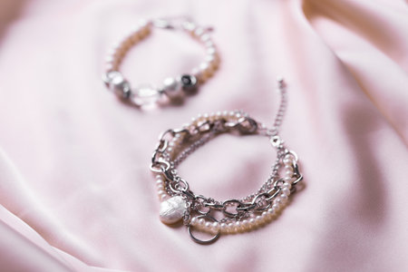 Jewelry on satin fabric with pearl bracelets and wheat elements. Handmade bijouterie And natural aesthetics in fashionの写真素材