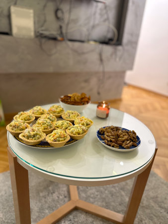Homemade appetizers on glass table with candlelight. Cozy atmosphere, hospitality, and the concept...