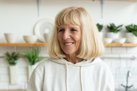 Portrait of a smiling senior woman at home. Happiness, simplicity and authentic everyday life