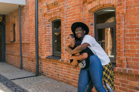 Happy african american couple laughing and hugging in the city street. Concept of love, friendship, fun, happiness and relationships. Copy spaceの写真素材
