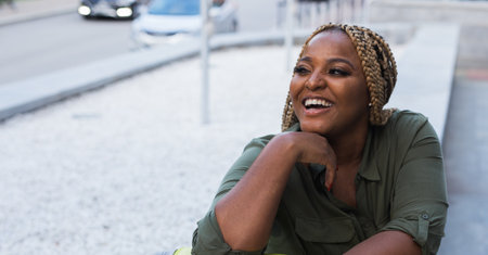African american Woman smiling and resting outdoors. Concept of relaxation, joy and positive emotions. Copy spaceの写真素材