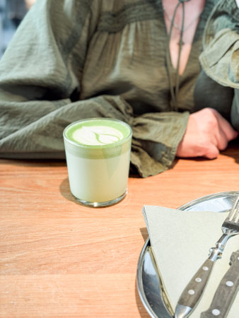 Green matcha latte on wooden table. Drinks, modern lifestyle and coffee shop concept