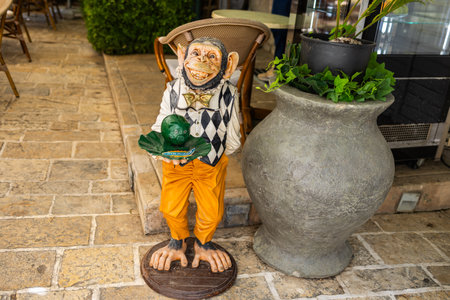 Funny monkey statue outside a cafe. Humor, street decor, and quirky visual marketing. Copy spaceの写真素材