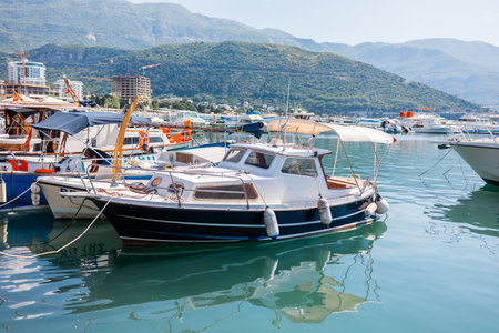 Luxury motor yacht docked at marina. Coastal lifestyle, leisure boating, and maritime tourism in summer harbor scene.の写真素材