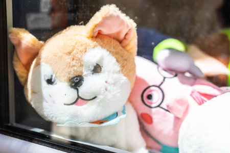 Stuffed dog and pig plush toys behind window glass. Childhood nostalgia, playful display, and toy...