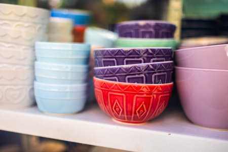 Colorful patterned ceramic bowls on display. Kitchenware variety, artisanal craftsmanship, and decorative design in vibrant ceramic tableware.の写真素材