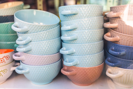 Colorful ceramic soup bowls on display. Kitchen decor, pastel dishware, and vibrant tableware with...