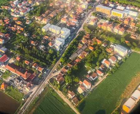 Aerial view of suburban neighborhood with houses and apartment buildings. Urban development, land use, and architectural variety in residential planning.の写真素材