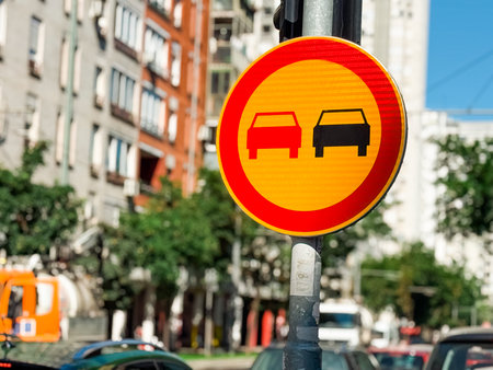 Traffic sign prohibiting overtaking with car symbols displayed on a circular board. Restriction, safety and regulation of vehicle mobility for prevention and controlled transportation flow.の写真素材