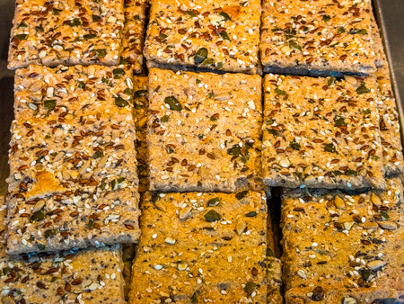 Whole grain seed crackers in square shape. Healthy nutrition, fiber and organic baked snacks.の写真素材