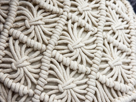 Closeup of macrame pattern with woven ropes. Handmade textile craft, bohemian decor and creative...