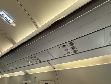 Airplane ceiling panel with lights and air vents. Passenger comfort, aviation technology, and flight...