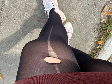 Torn black tights. Imperfection, daily mishap and authenticity in street fashion and urban lifestyle...